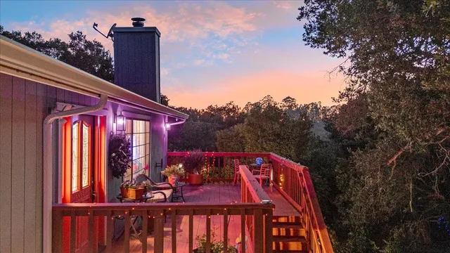 a view of a patio with couches and table and chairs and potted plants