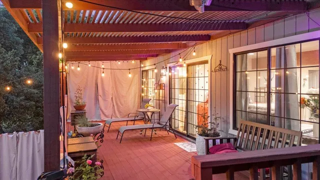 a view of a patio with a table and chairs