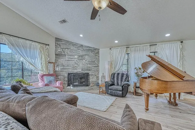 a living room with furniture and wooden floor