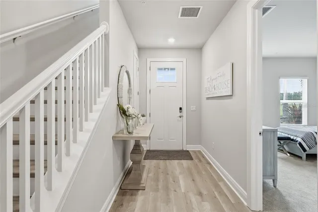 a kitchen with stainless steel appliances granite countertop a stove top oven a refrigerator a sink and kitchen island with chairs