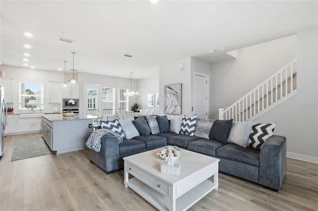 a large kitchen with a stove top oven a sink a counter space and cabinets