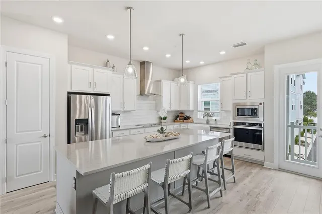 a kitchen with a dining table and chairs