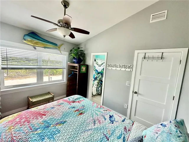 a bedroom with a bed dresser and a window