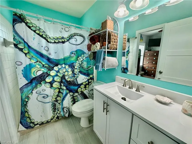 a bathroom with a sink mirror and vanity
