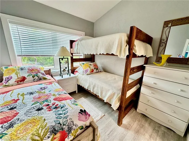 a bedroom with bed and a window