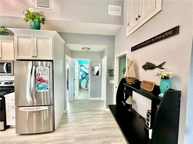 a hallway with furniture and wooden floor