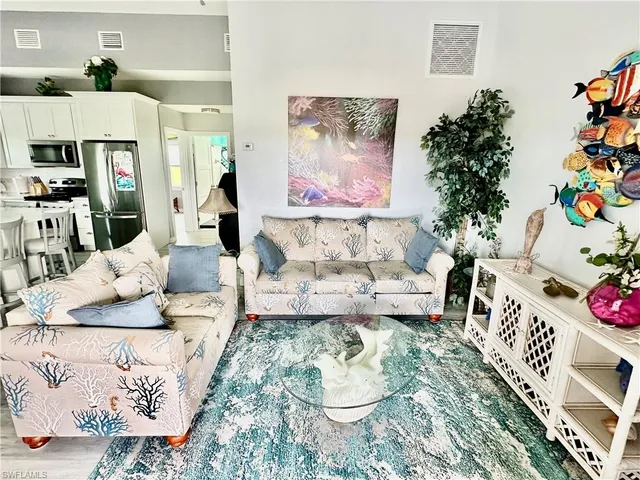 a living room with furniture and flowers