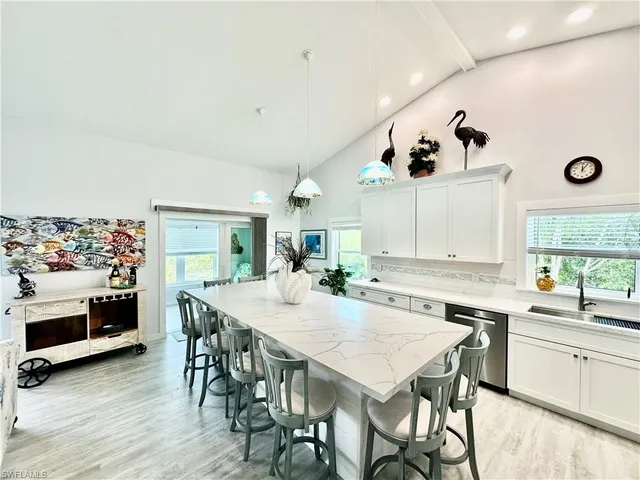 a view of a dining room with furniture and a large window