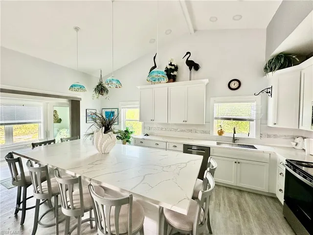 a large kitchen with a table and chairs in it