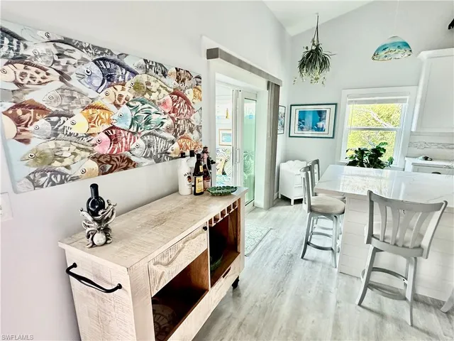 a living room with a couch and paintings on the wall