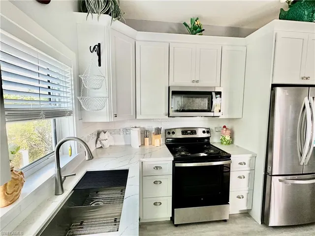 a kitchen with stainless steel appliances a stove a microwave and a refrigerator