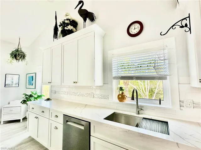 a kitchen with a sink and a stove