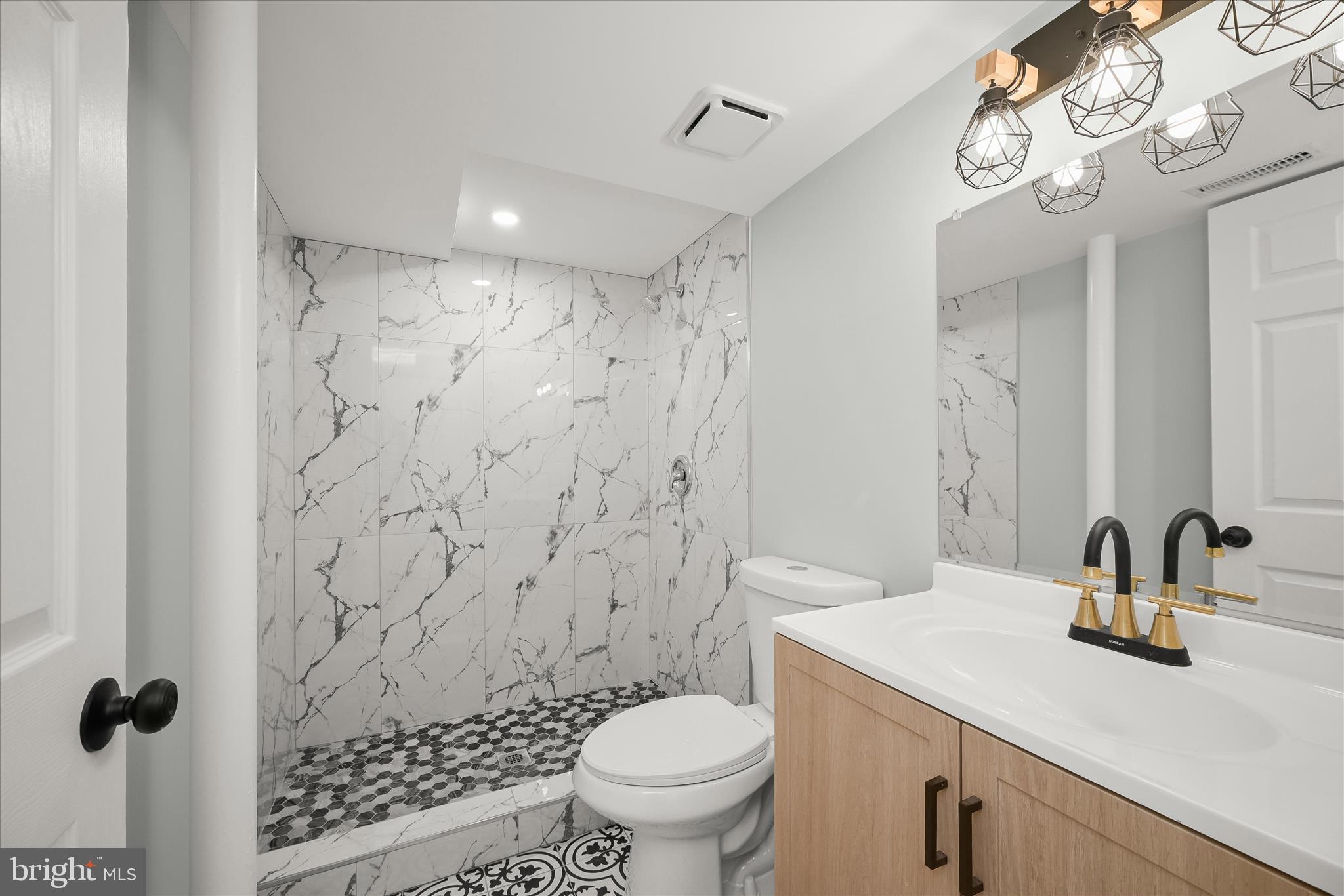 9720 Hedin Drive Silver Spring, MD 20903 - Photo 62 of 79 a bathroom with a sink toilet a mirror and shower