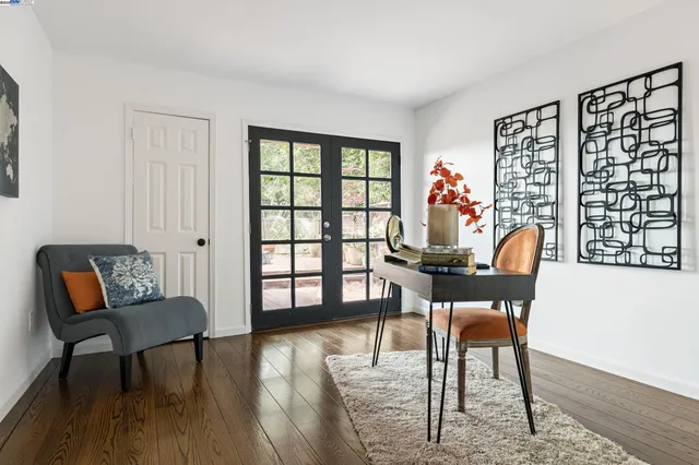 a dining room with furniture and wooden floor