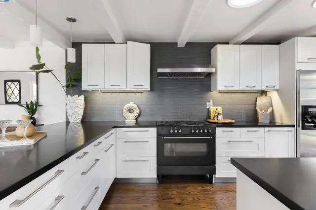 a kitchen with granite countertop a stove and cabinets