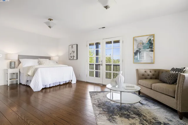 a bedroom with a bed couch and a window