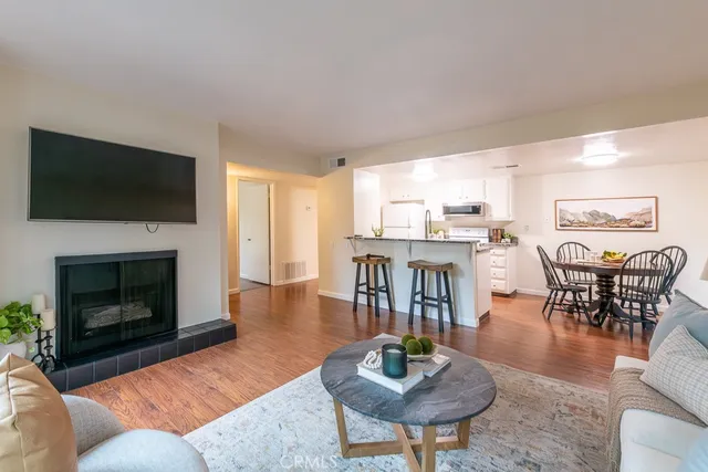 a living room with furniture a fireplace and a flat screen tv