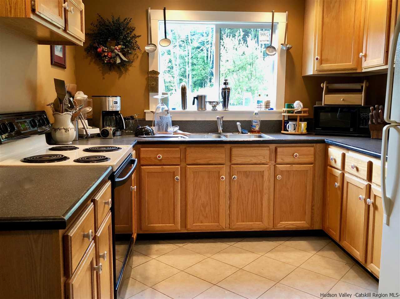 1265 Schuman Road Roxbury, NY 12474 - Photo 4 of 12 a kitchen with stainless steel appliances granite countertop a stove a sink and a microwave