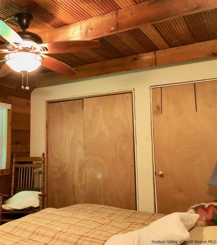 1265 Schuman Road Roxbury, NY 12474 - Photo 7 of 12 a bedroom with a bed and wooden floor
