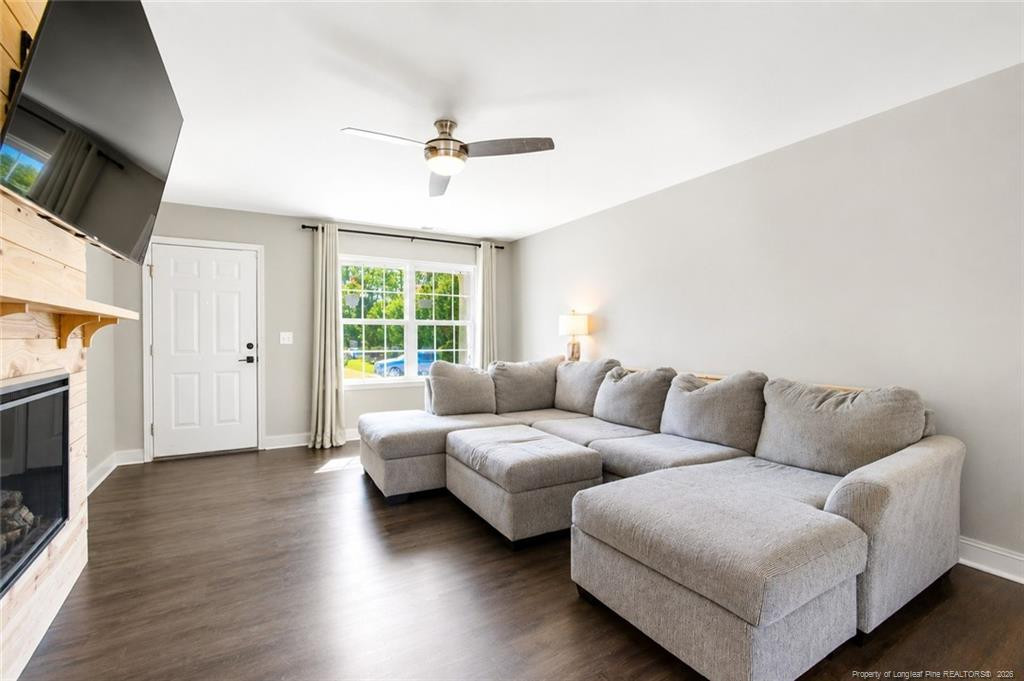 334 Crane Way Bunnlevel, NC 28323 - Photo 5 of 45 a living room with furniture a flat screen tv and a fireplace