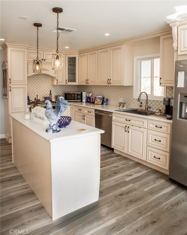 a kitchen with cabinets a sink and appliances