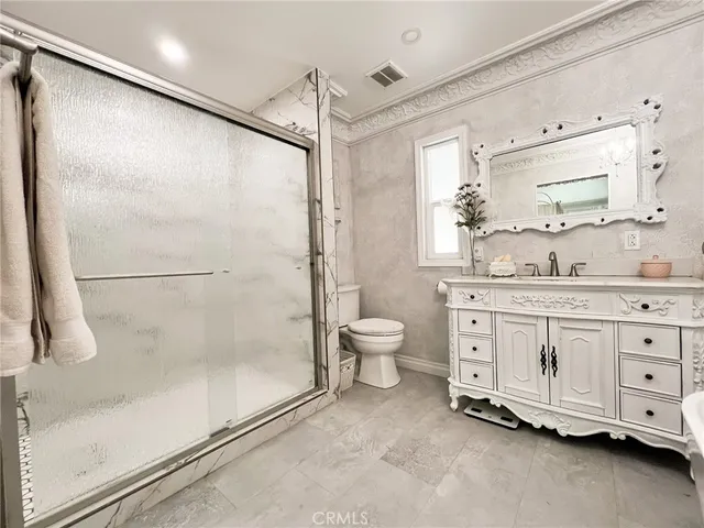 a view of a bedroom with wooden floor and bed