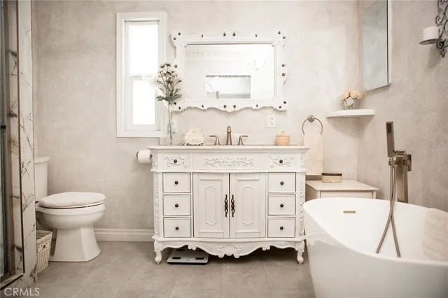 a living room with furniture a mirror and a chandelier