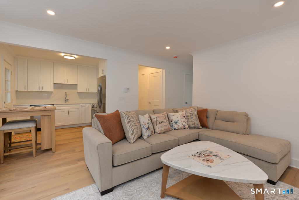 63 Glen Ridge Court, Unit 63 New Milford, CT 06776 - Photo 1 of 12 a living room with furniture and kitchen view