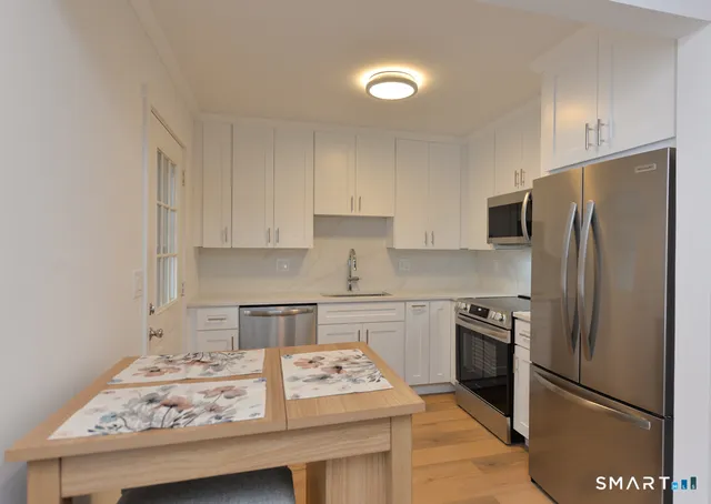 a kitchen with a stove a refrigerator and a sink