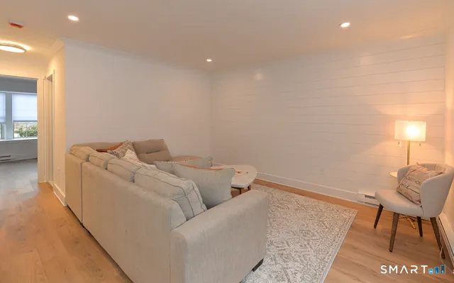 a living room with furniture and a rug