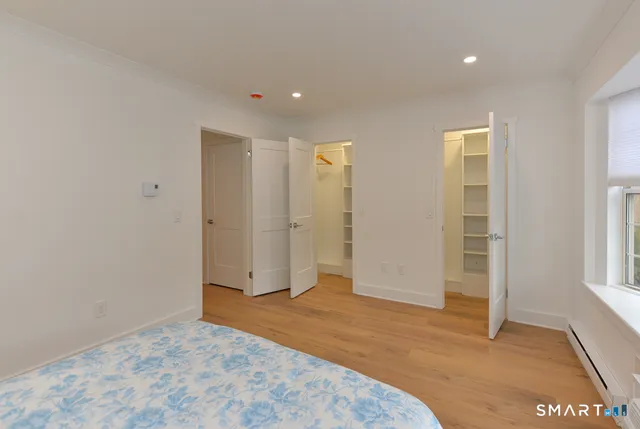 an empty room with closet and windows