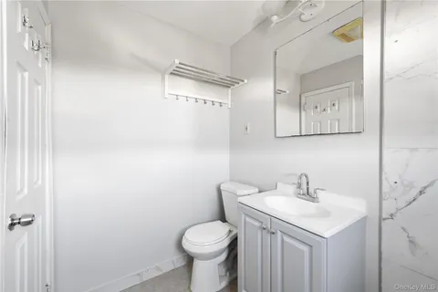 a bathroom with a sink toilet and vanity