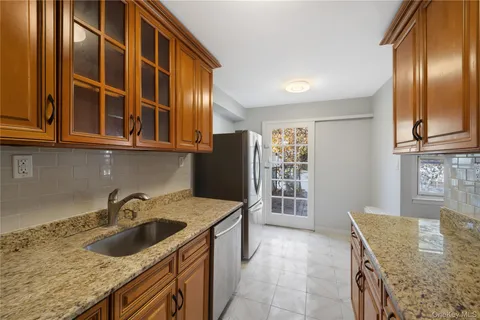 a kitchen that has a sink cabinets counter space and appliances