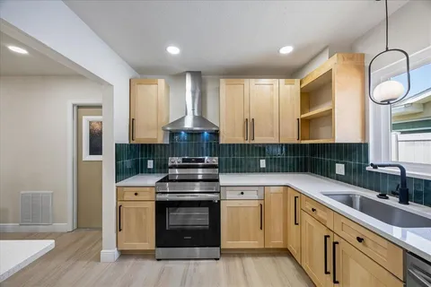 a kitchen with stainless steel appliances a refrigerator and a stove