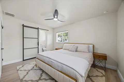 a bedroom with a bed and a chandelier