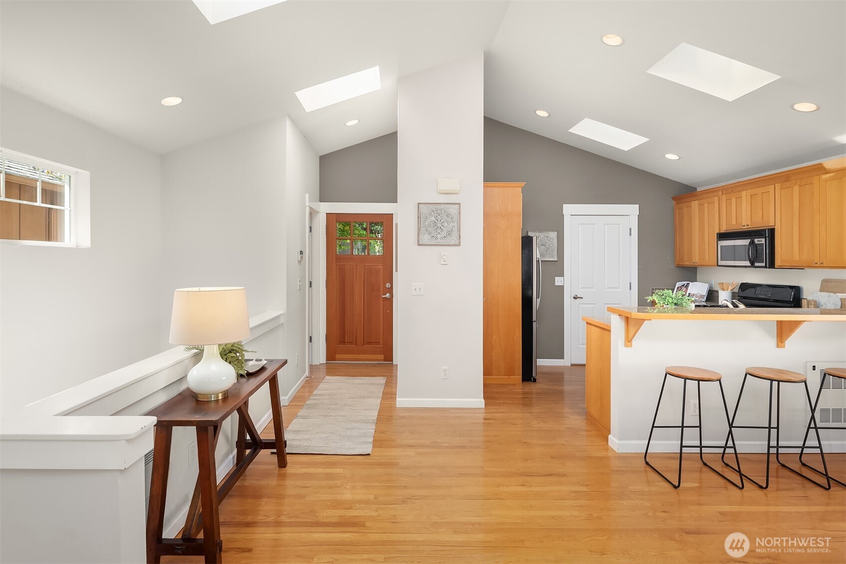 2452 Southwest Webster Street Seattle, WA 98106 - Photo 11 of 28 a living room with furniture and a dining table with kitchen view