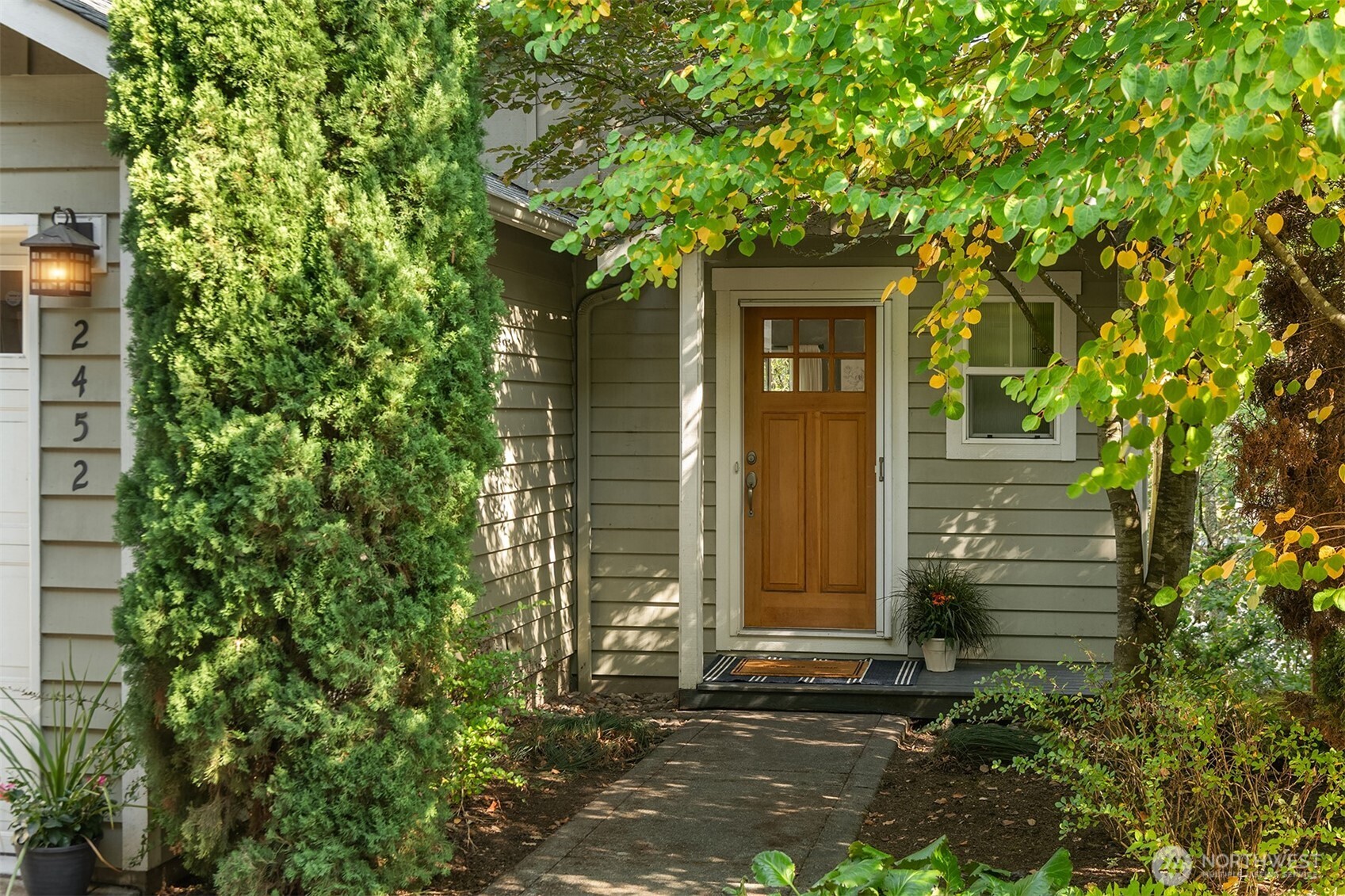 2452 Southwest Webster Street Seattle, WA 98106 - Photo 2 of 28 a front view of a house with a tree
