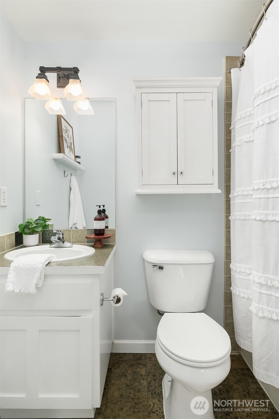 2452 Southwest Webster Street Seattle, WA 98106 - Photo 21 of 28 a bathroom with a toilet a sink and a mirror