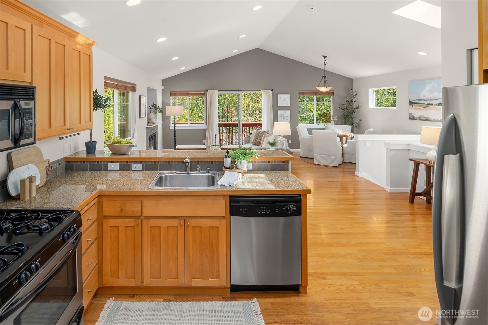 2452 Southwest Webster Street Seattle, WA 98106 - Photo 9 of 28 a kitchen with stainless steel appliances granite countertop a sink stove and refrigerator