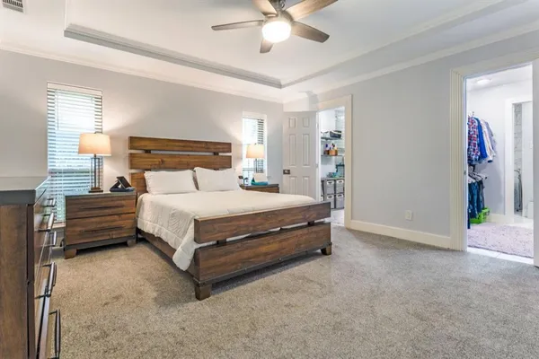 a bedroom with a bed and a ceiling fan