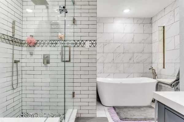 a bathroom with a bathtub and shower