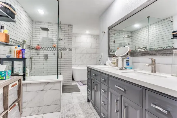 a bathroom with a sink a toilet and shower