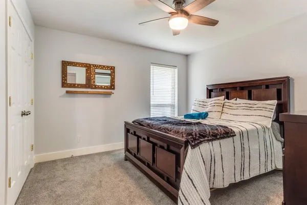 a bedroom with a bed and a chandelier