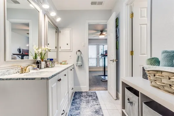 a spacious bathroom with a granite countertop sink and a mirror