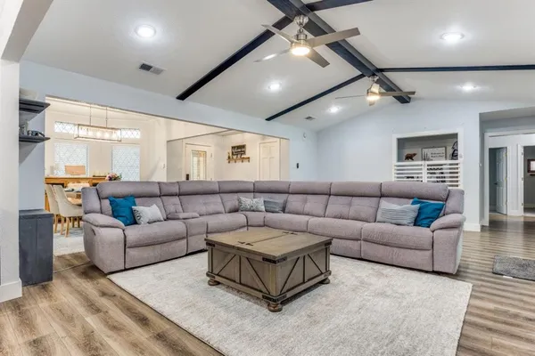 a living room with furniture and a ceiling fan