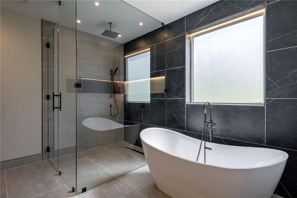 71 Ramey Road Sugar Hill, GA 30518 - Photo 12 of 58 a bathroom with a granite countertop sink mirror and tub