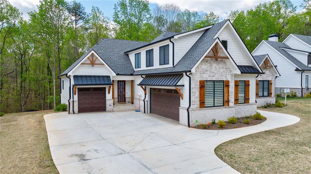 71 Ramey Road Sugar Hill, GA 30518 - Photo 20 of 58 a front view of a house with a yard and garage