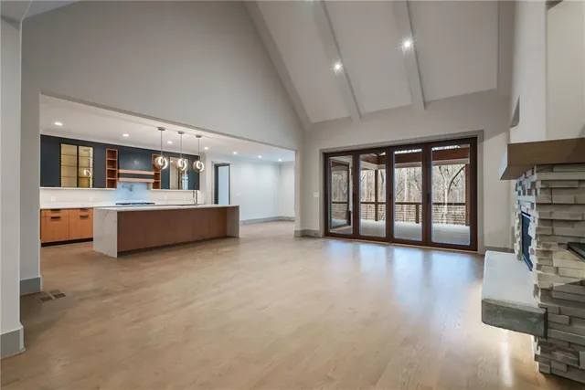 a large kitchen with stainless steel appliances granite countertop a large stove and a sink with cabinets