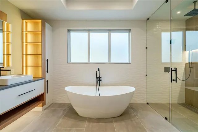 a bathroom with a bathtub and a shower
