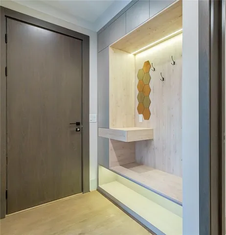 a view of an empty room with wooden floor fireplace and a window